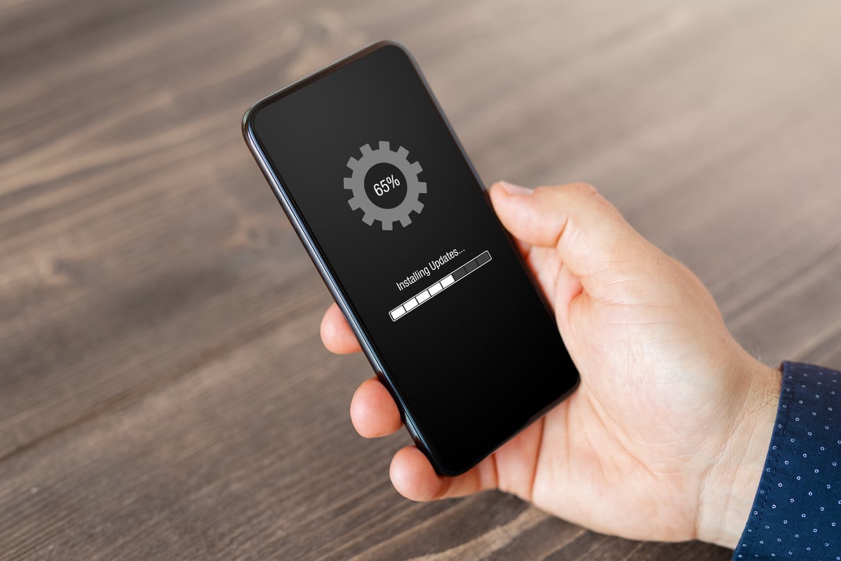 Person Installing Software Updates on Mobile Phone